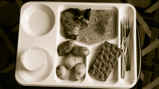 Food arranged in different compartments on a moulded food tray