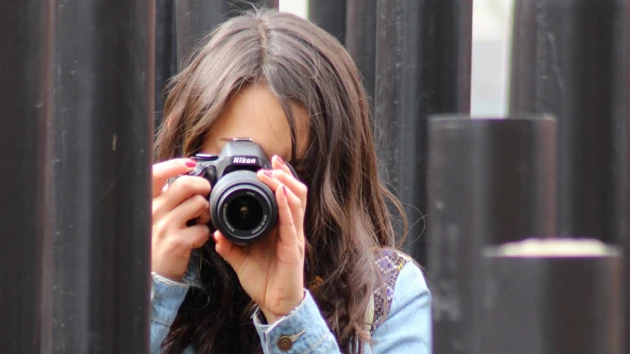 A woman taking a picture of herself with a camera.