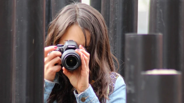 A woman taking a picture of herself with a camera.