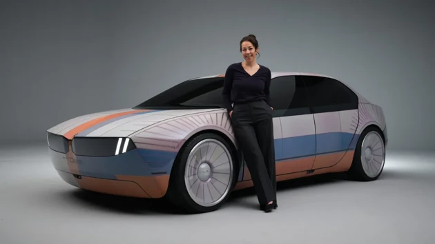 Stella in fornt of a car