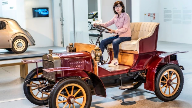 Photo of Yuhan Zhang sitting in a historic car at Skoda museum.