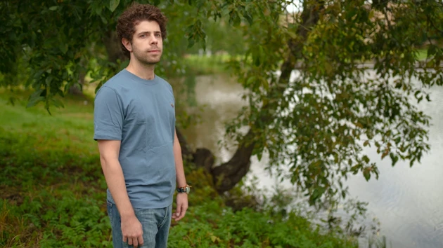 Photo of Nikiforos Staveris standing next to the campus pond