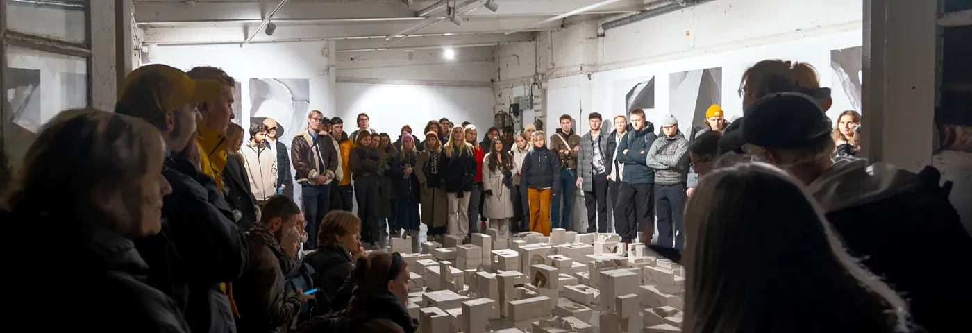 Image from public exhibition with people standing around landscape model