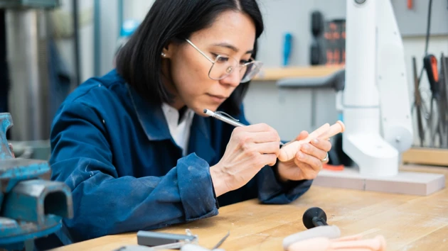 Photo of Natalia Ikebara working on a design in the studio