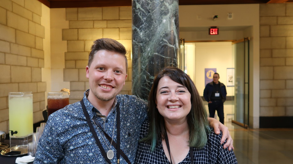A man and a women smiling at the camera