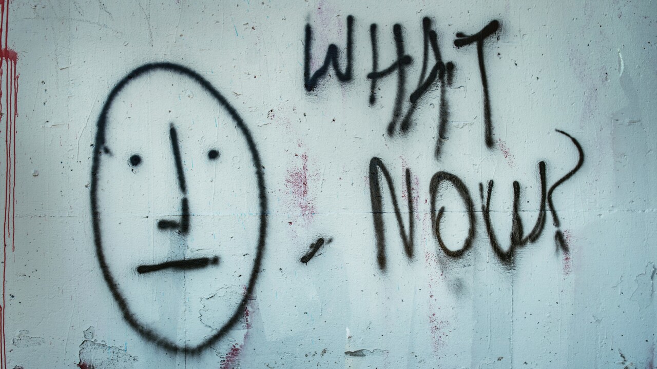 Graffitti på en vägg med texten What now?