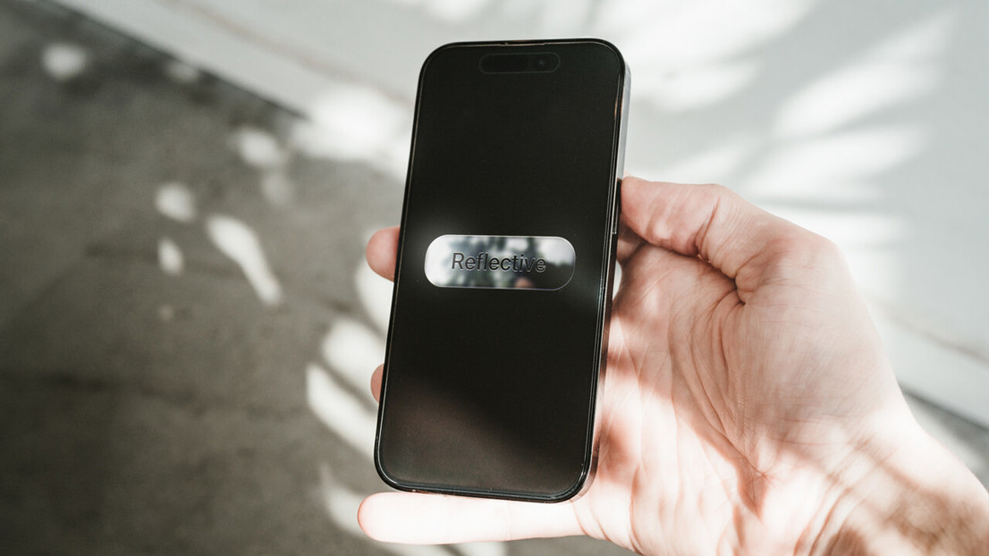 The reflective material uses the device’s front camera to project the user’s environment onto the device. This creates an interplay between the user’s presence, lights and shadows.