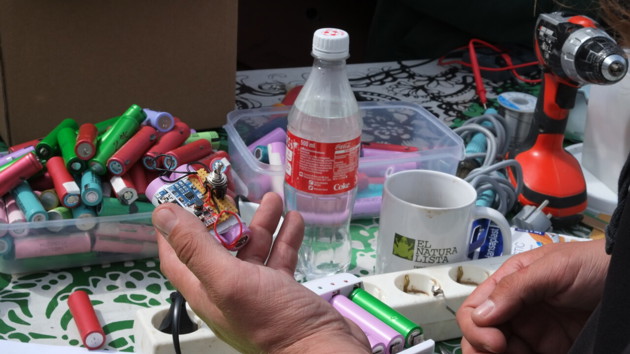 Community powerbank workshop, Open Source Circular Economy Days Helsinki, June 2016. Sustainability oriented activist groups often host workshops to encourage learning about issues hands-on. Here they are taking lithium batteries from discarded laptops and teaching people how to wire them together to create USB chargers.